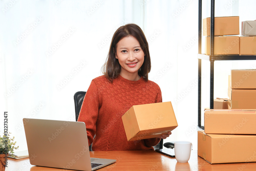 Shipping shopping online, young attractive entrepreneur business woman working at home office with many packaging cardboard box Shipping shopping online, young attractive entrepreneur business woman working at home office with many packaging cardboard box