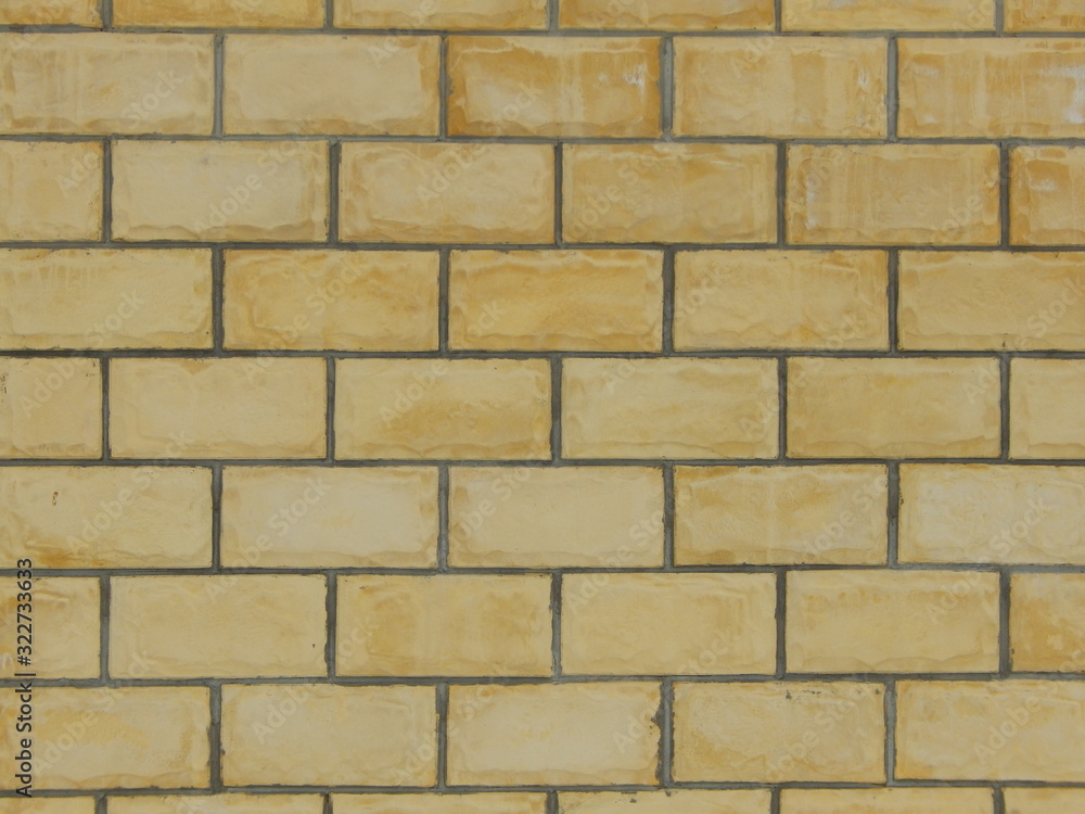 fragment of a wall of light brown blocks with uneven texture fragment of a wall of light brown blocks with uneven texture