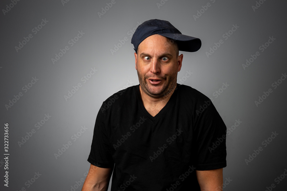 man in black vneck teeshirt and backwards hat man in black vneck teeshirt and backwards hat