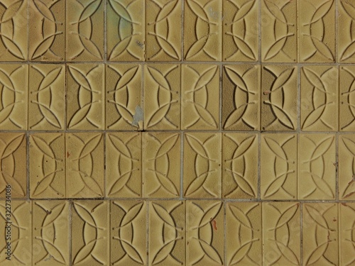 Tableau sur toile Fragment of an old wall lined with tiles of indefinite color and smooth texture