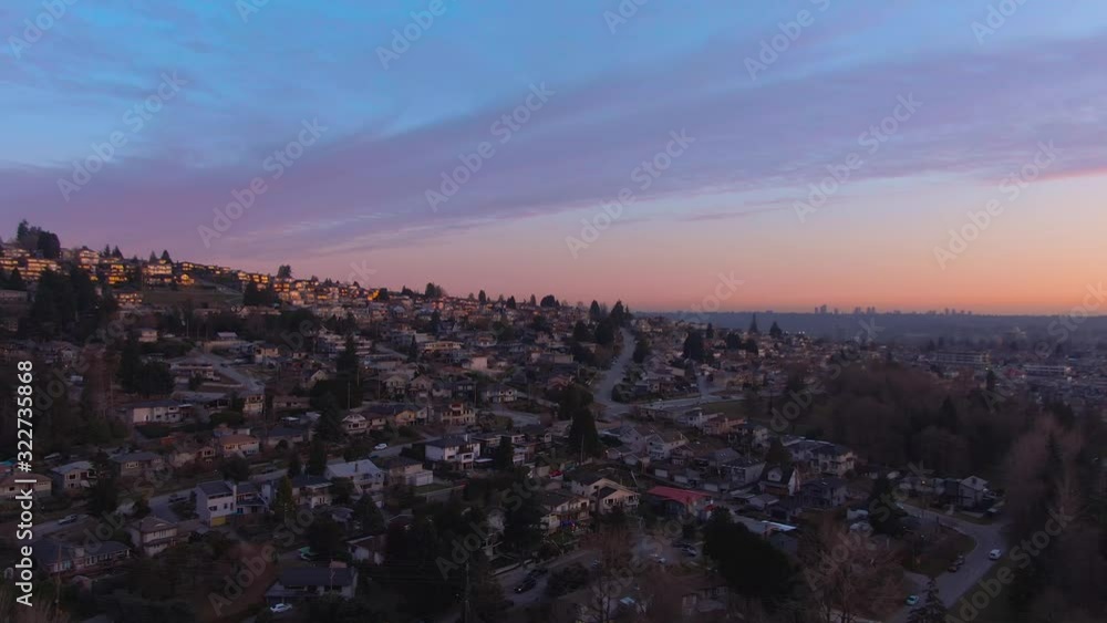 Aerial Panoramic View of a modern city during a colorful and cloudy sunset. Taken in Burnaby, Greater Vancouver, British Columbia, Canada. Aerial Panoramic View of a modern city during a colorful and cloudy sunset. Taken in Burnaby, Greater Vancouver, British Columbia, Canada.