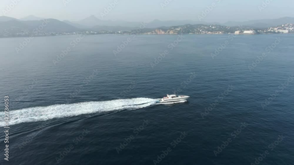 Aerial view of yacht boat driving along spanish coastline Aerial view of yacht boat driving along spanish coastline