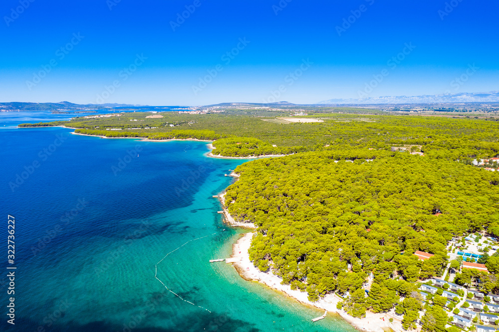 Croatia, beautiful blue seascape, shore with pine forest on Adriatic sea near Pakostane, drone aerial view