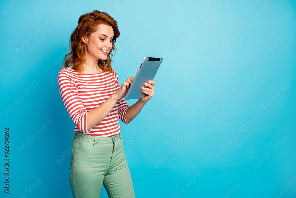 Portrait of positive cheerful woman use tablet rest relax chilling searching blog post apps wear good look jumper isolated over blue color background Portrait of positive cheerful woman use tablet rest relax chilling searching blog post apps wear good look jumper isolated over blue color background