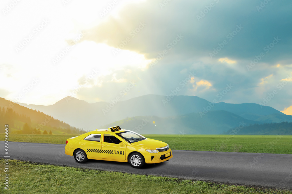 Yellow taxi car on asphalt highway outdoors