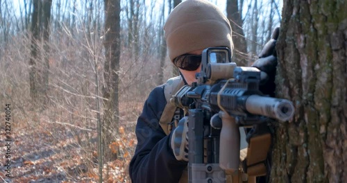 Male from private military company with rifle in the forest	