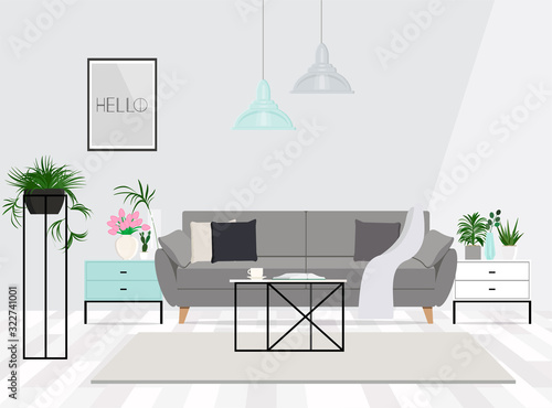 Luxurious living room interior with a grey couch, lamps, coffee table and plants.