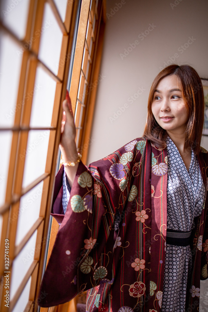 Lovely Asian Girl wearing Yukata japanese tradditional cloth in traddition Japan style  in Tatami room. Face on happy time in Japan with copy space.