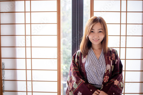 Lovely Asian Girl wearing Yukata japanese tradditional cloth in traddition Japan style  in Tatami room. Face on happy time in Japan with copy space. photo