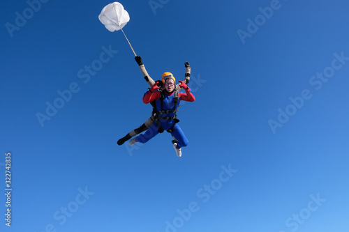 Skydiving. Tandem jump. Two men are having fun in the sky.
