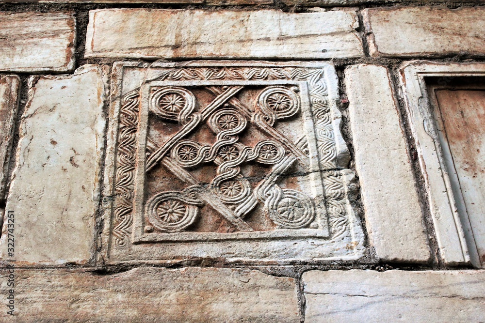 Carved stones decorate the exterior wall of an old Christian orthodox church in Athens, Greece