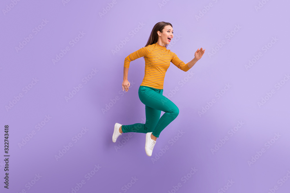 Full length body size view of nice attractive lovely cheerful cheery glad excited dreamy energetic girl running fast enjoying speed movement isolated on violet purple lilac pastel color background