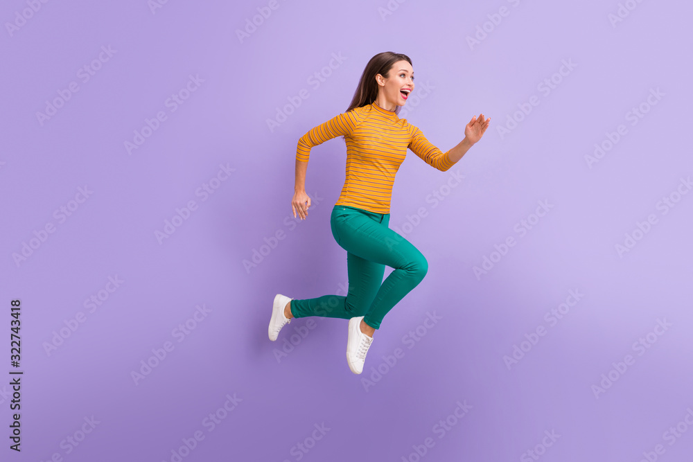 Full length body size view of nice attractive lovely cheerful cheery glad excited dreamy energetic girl running fast enjoying speed movement isolated on violet purple lilac pastel color background Full length body size view of nice attractive lovely cheerful cheery glad excited dreamy energetic girl running fast enjoying speed movement isolated on violet purple lilac pastel color background