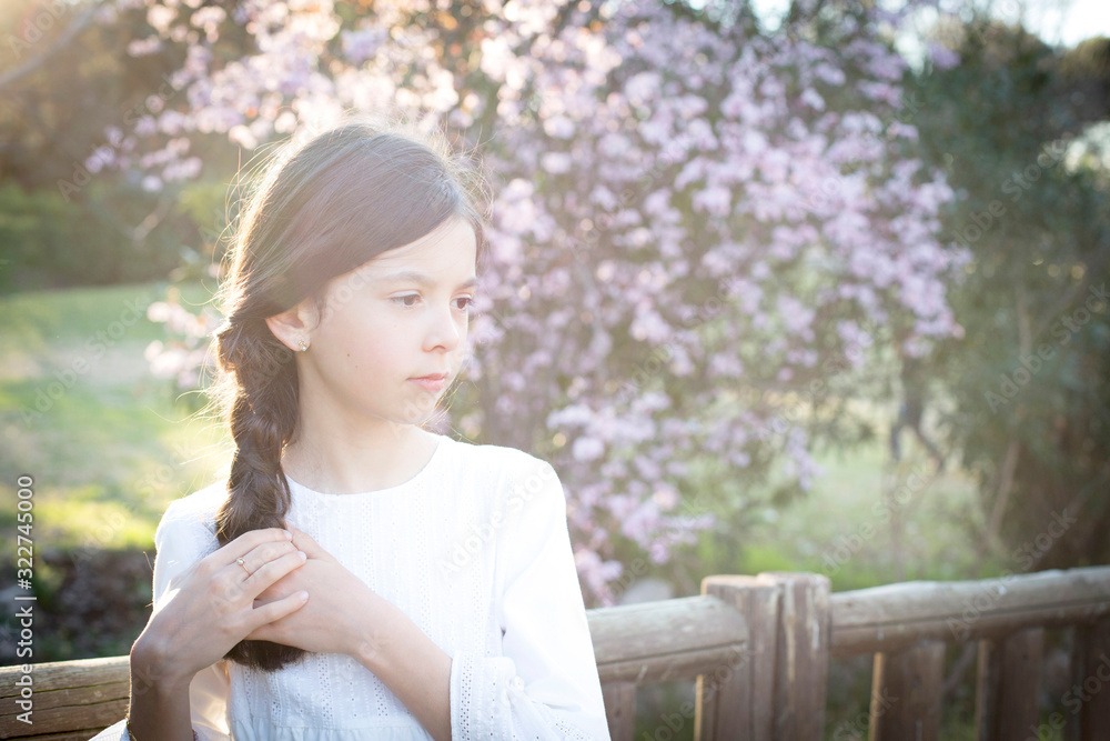 Beautiful girl with white communion dress in nature Beautiful girl with white communion dress in nature