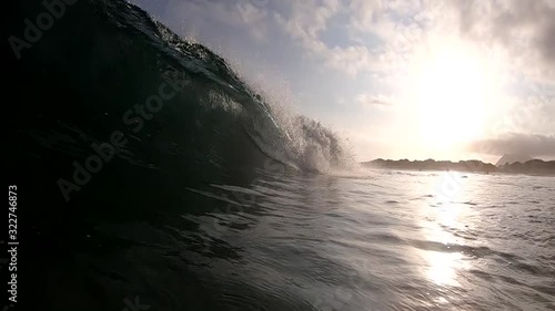 Slow Motion Wave Barreling Over Camera with Sunset Background