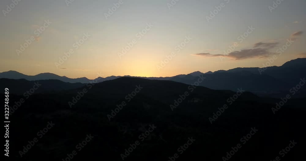 Dark outline of the mountains and colorful sunset, yellow and orange sky, 4k Dark outline of the mountains and colorful sunset, yellow and orange sky, 4k
