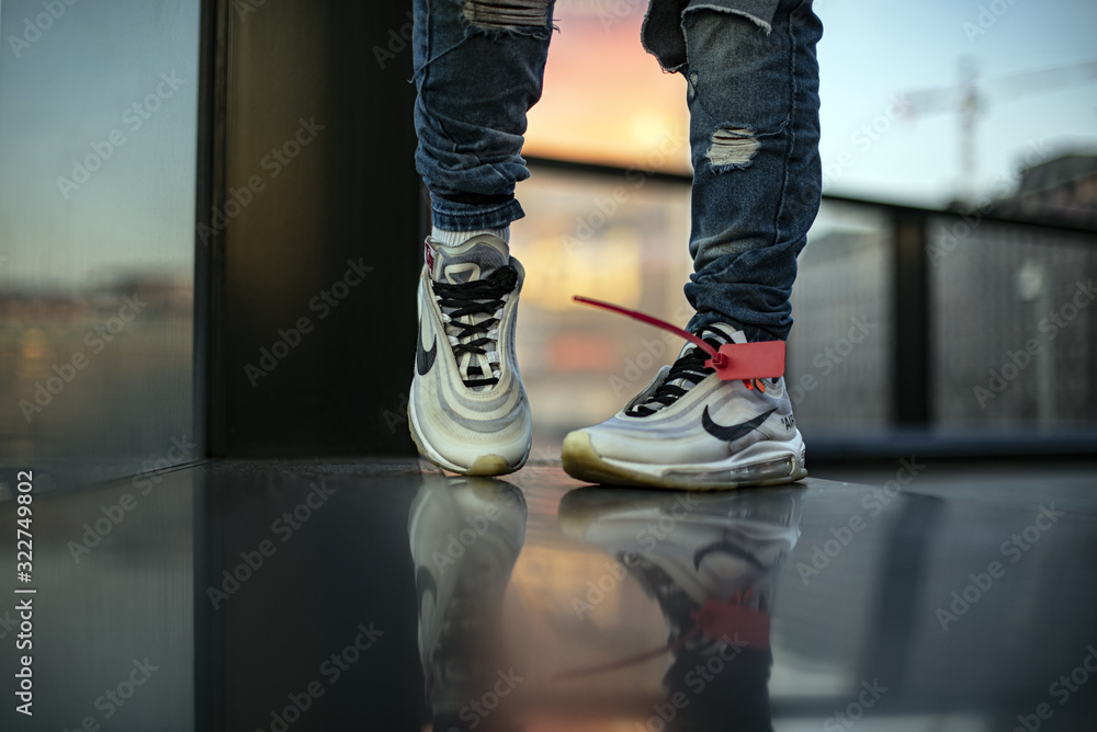 Young man wearing a pair of Nike Air Max 97 Off-White Stock Photo | Adobe  Stock