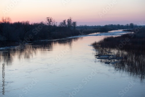 the nature of the spring flood the river ice trees water reflection