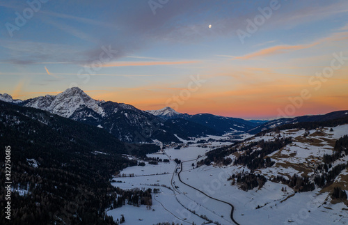 San Candido Innichen by sunrise in South Tyrol Alto Adige, Italy during winter season. Aerial drone shot in january 2020