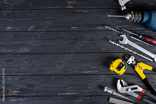 Set of working tools on wooden rustic background. Top view. Copy space