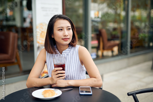 Woman enjoys fresh coffee in the morning at coffee shop