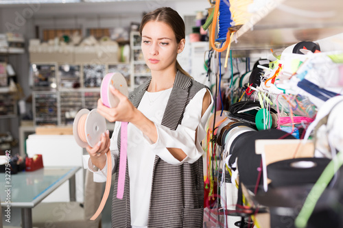 Seamstress looking for ribbons in haberdasher shop