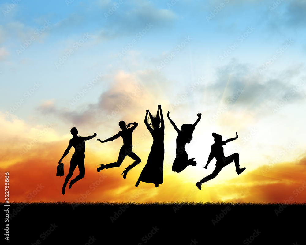 Silhouette of women jumping in sunset.