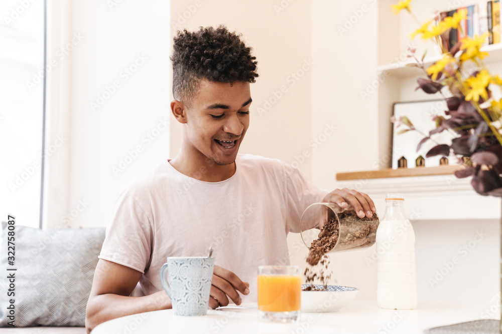 African guy in the morning at the kitchen have a breakfast. African guy in the morning at the kitchen have a breakfast.