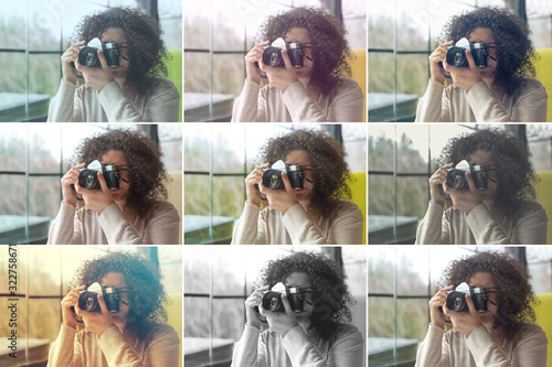 Curly haired photographer woman holding her camera in a cafe and shooting photo