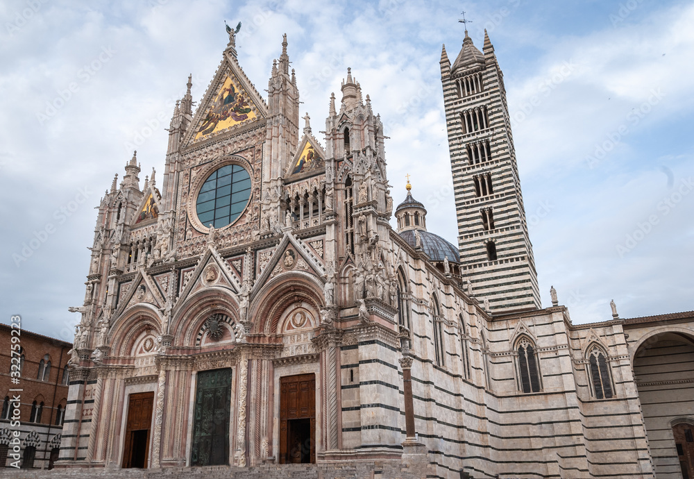 Siena cathedral (Duomo di Siena) against a bright blue sky in Tuscany, Italy