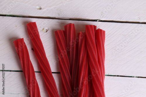 sweet red gummy licorice in color background photo