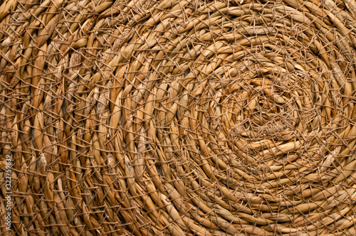 Close Up of a Round Esparto Grass Mat, Natural Fiber Background. photo