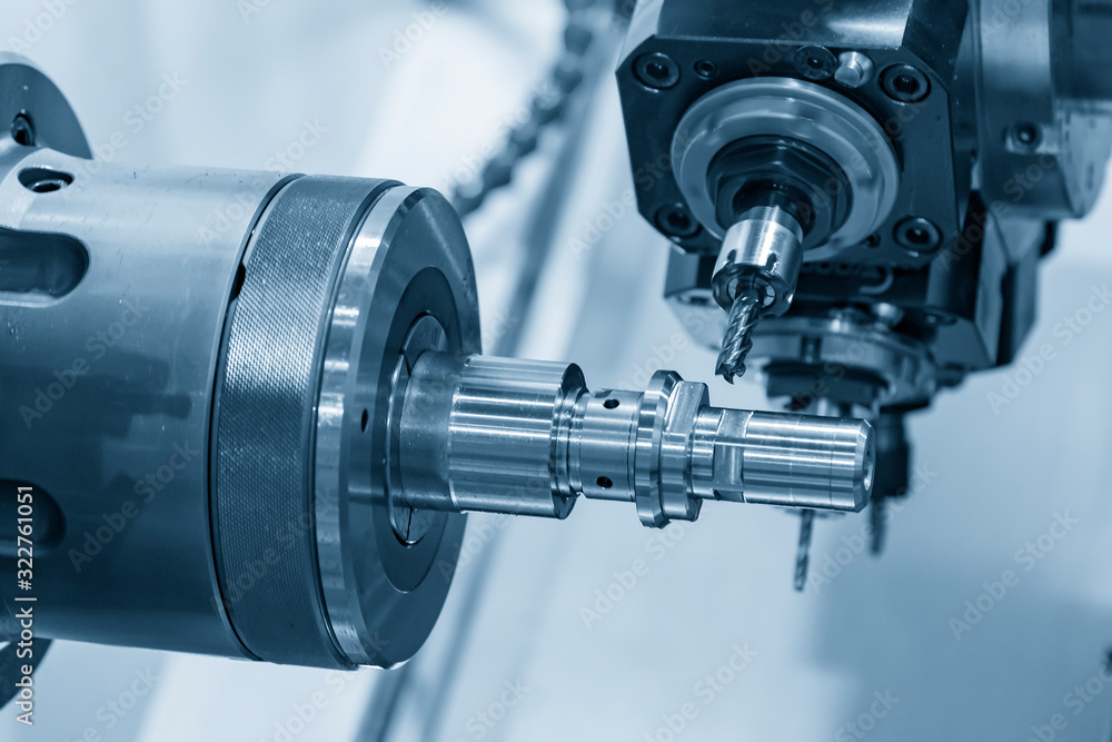 The multi tasking CNC lathe machine in metal working process milling the metal shaft parts . The hi-technology metal working processing by CNC turning machine . The multi tasking CNC lathe machine in metal working process milling the metal shaft parts . The hi-technology metal working processing by CNC turning machine .