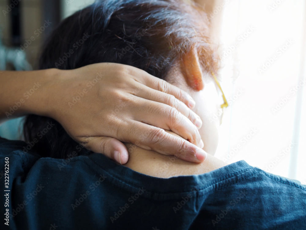 Αυτοκόλλητο Asian thai women headache, occipital pain and use hand to massage back of neck to relax muscles and relieve pain