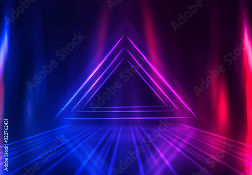 Dark abstract futuristic background. Geometric laser figure in the center of the stage. Neon blue-pink rays of light on a dark background