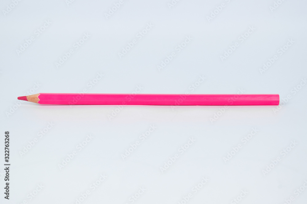 Pink colored sharp wood pencil crayon placed on an isolated white background Pink colored sharp wood pencil crayon placed on an isolated white background
