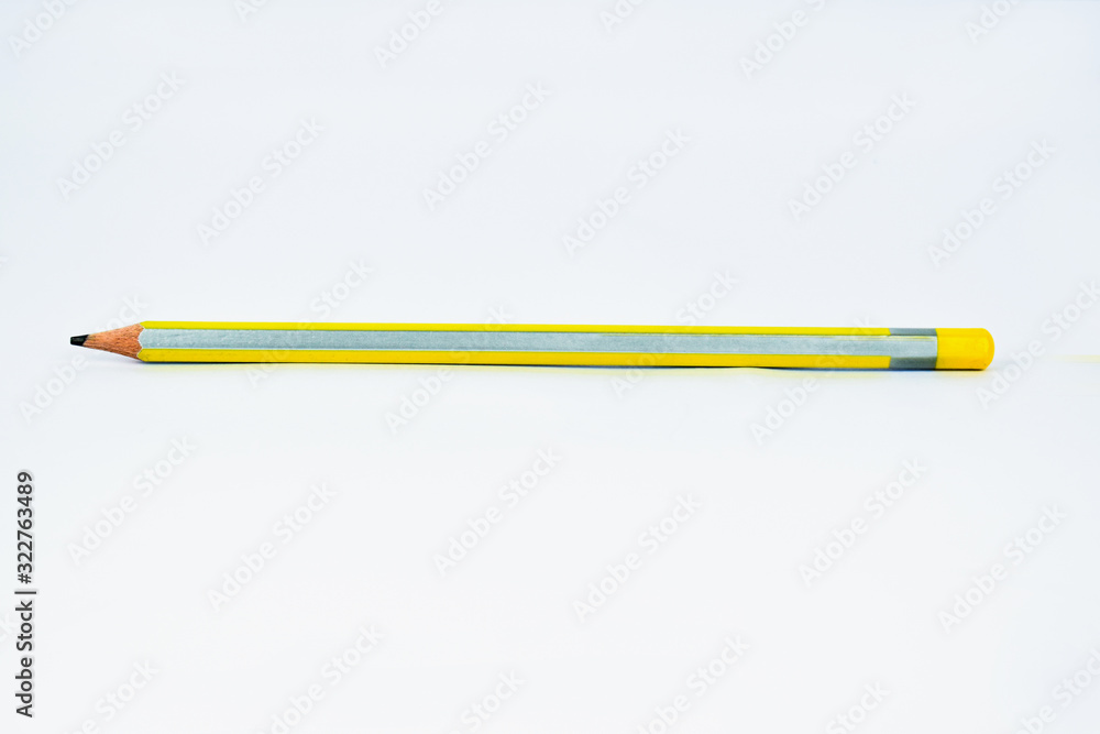 Yellow-silver sharpened wood pencil crayon isolated on a white background Yellow-silver sharpened wood pencil crayon isolated on a white background