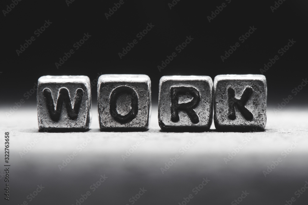 Naklejka premium Work concept. 3d inscription on metal cubes on a gray black background isolated