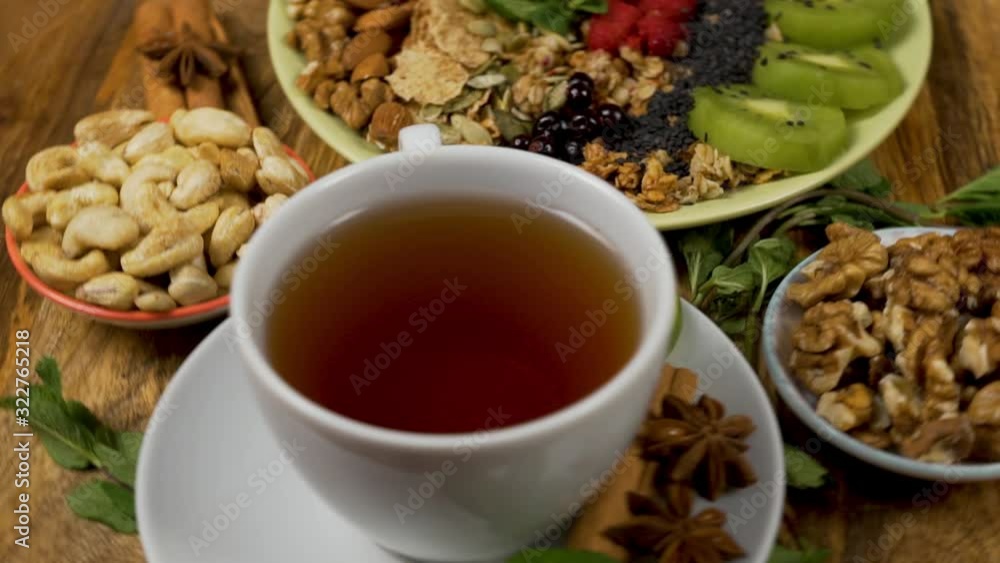 Healthy Vegetarian Breakfast with Nuts, Muesli, Smoothies, Seeds, Fruit and Flavored Tea Healthy Vegetarian Breakfast with Nuts, Muesli, Smoothies, Seeds, Fruit and Flavored Tea