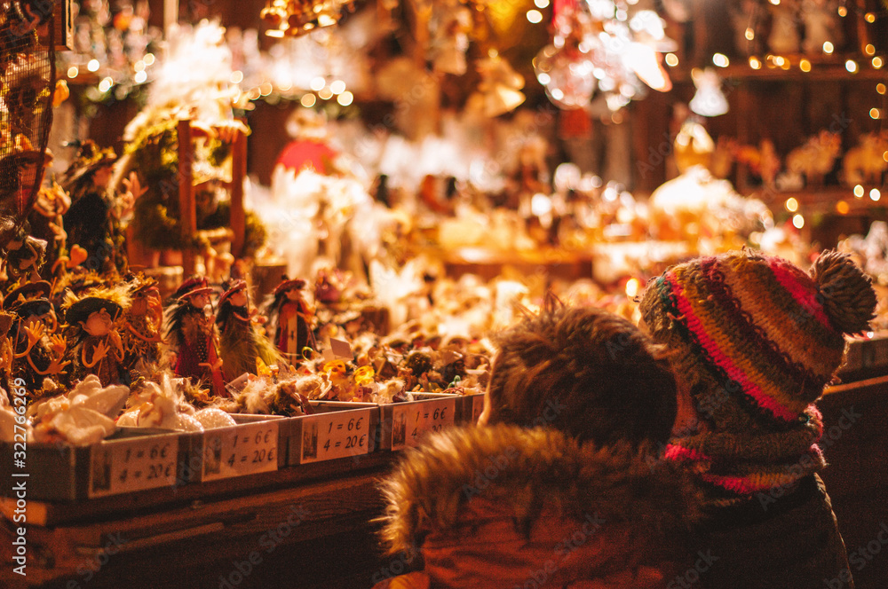 Fototapeta premium Children enjoying the Christmas stalls on the Christmas Market of Bruges, Belgium, Europe