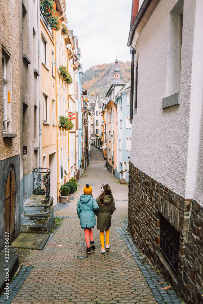 Children walking in the streets of Cochem, Germany, Europe during winter on a family vacation