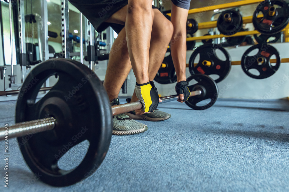 sportsman lifting a barbell at the gym sportsman lifting a barbell at the gym