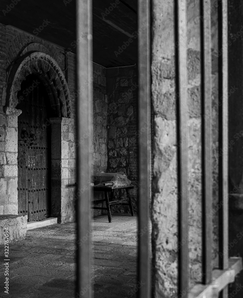 Black and white vertical photo of the door of a medieval stone building Black and white vertical photo of the door of a medieval stone building