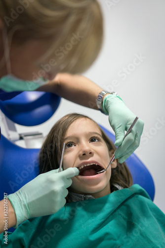 Young Smiling Boy Posing Before Regular Dental Check Up in Clinic