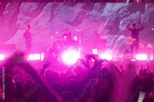 Crowd raising their hands and enjoying great music, concert festival party. Audience with hands raised at a music festival