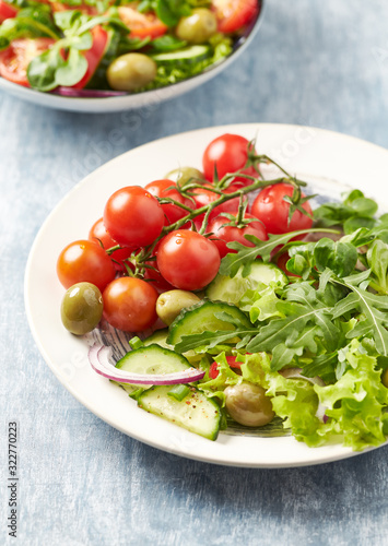 Healthy salad with green olives, cherry tomatoes and rocket. Close up.	