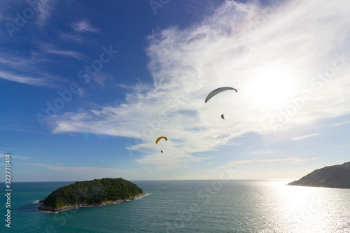 Two paragliders over the small island