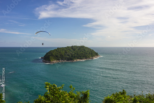 Paragliding over the small island in the sea
