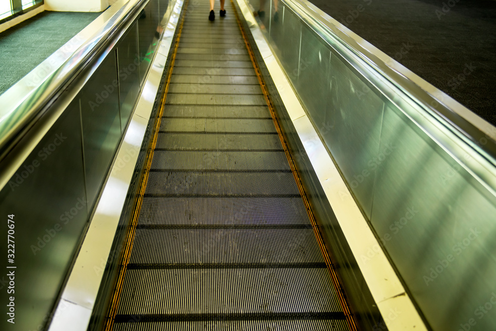 The automatic escalators in airport terminal The automatic escalators in airport terminal