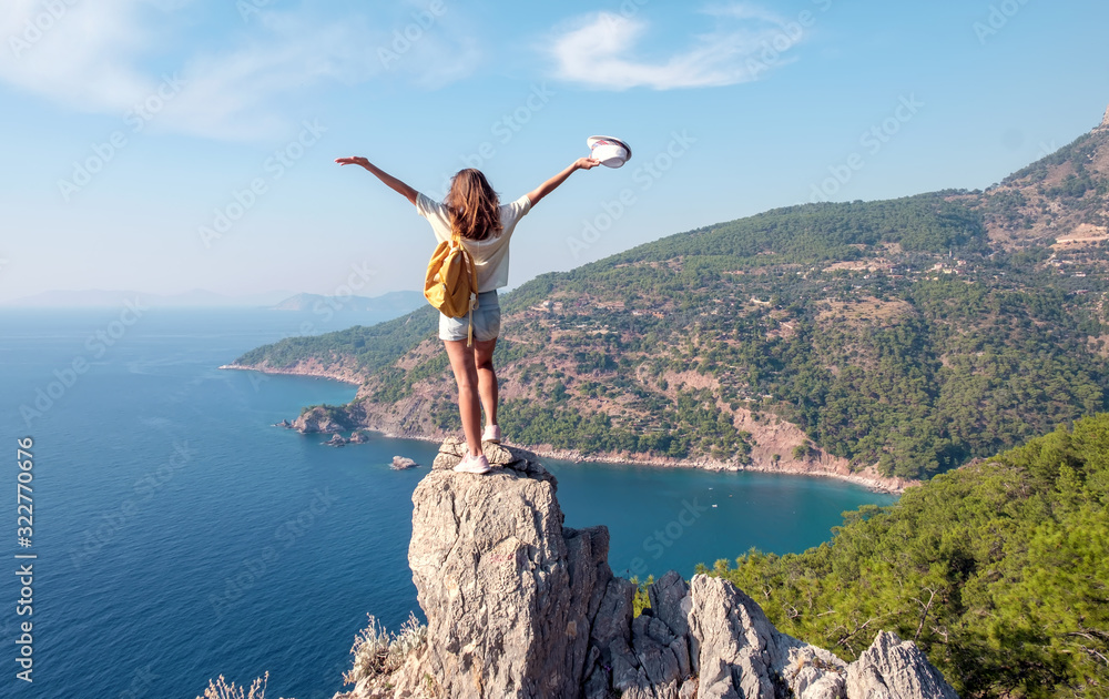 Hiker girl on the mountain top, concept of freedom, victory, active lifestyle, Kabak beach, Oludeniz, Turkey Hiker girl on the mountain top, concept of freedom, victory, active lifestyle, Kabak beach, Oludeniz, Turkey